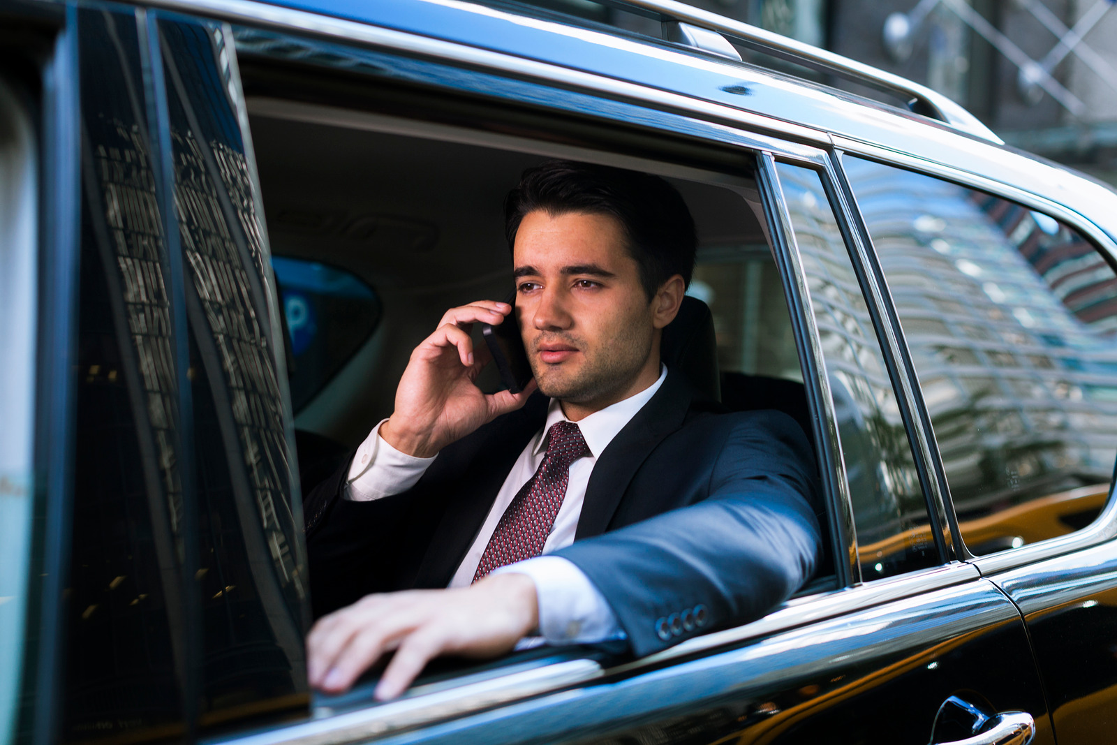 Business executive on a phone call in a limousine for Corporate Limo Vancouver.